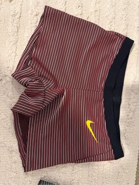 Nike Women’s  Red and White Striped Shorts with Navy Waistband and Yellow Swoosh
